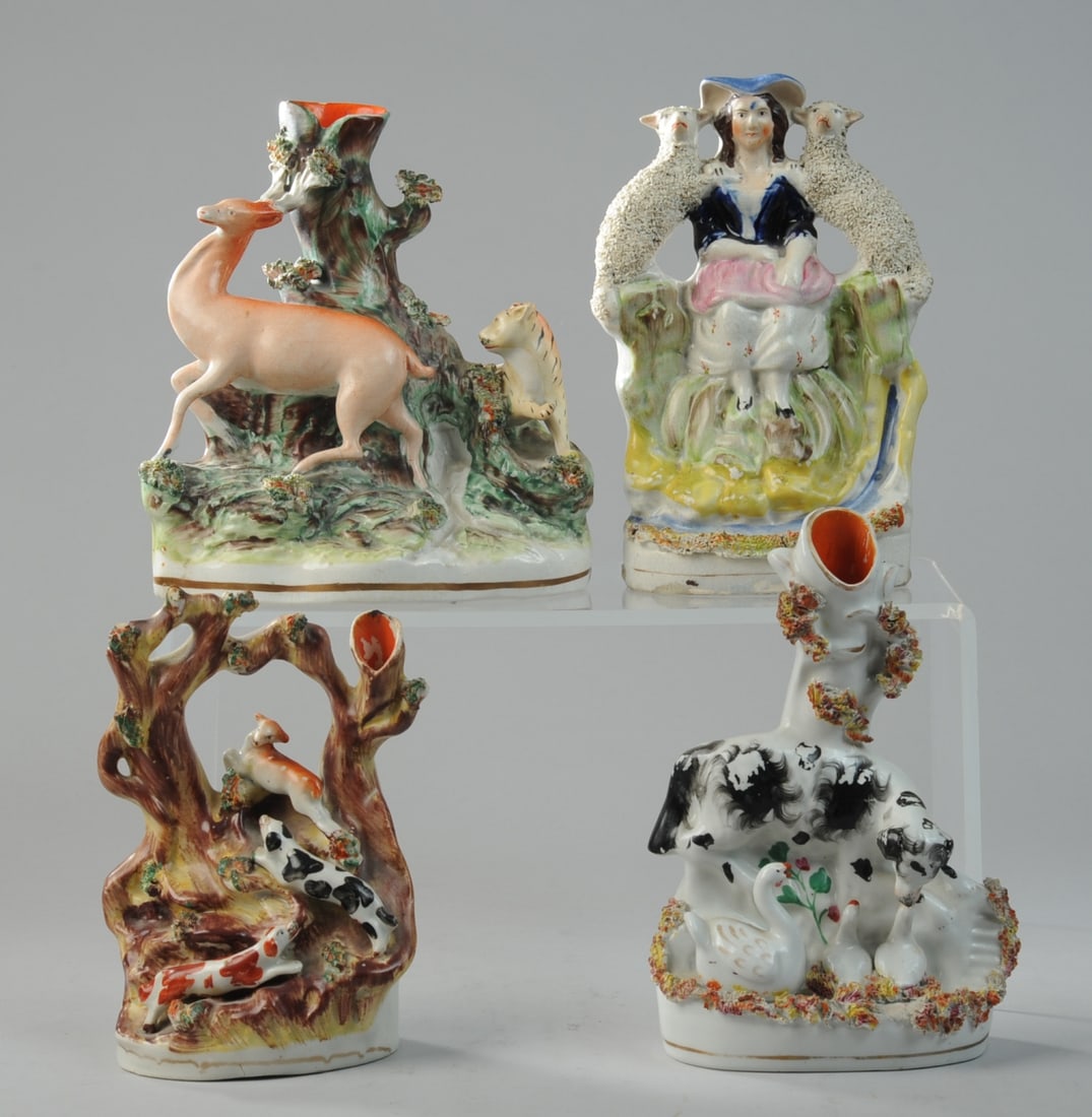 Four 19th C. Staffordshire Pottery Figures: Group of four Staffordshire pottery mantel figures, circa mid to late 19th century. Includes a spill vase with dog and geese, a shepherdess seated with two lambs, a hunting spill vase with hounds and