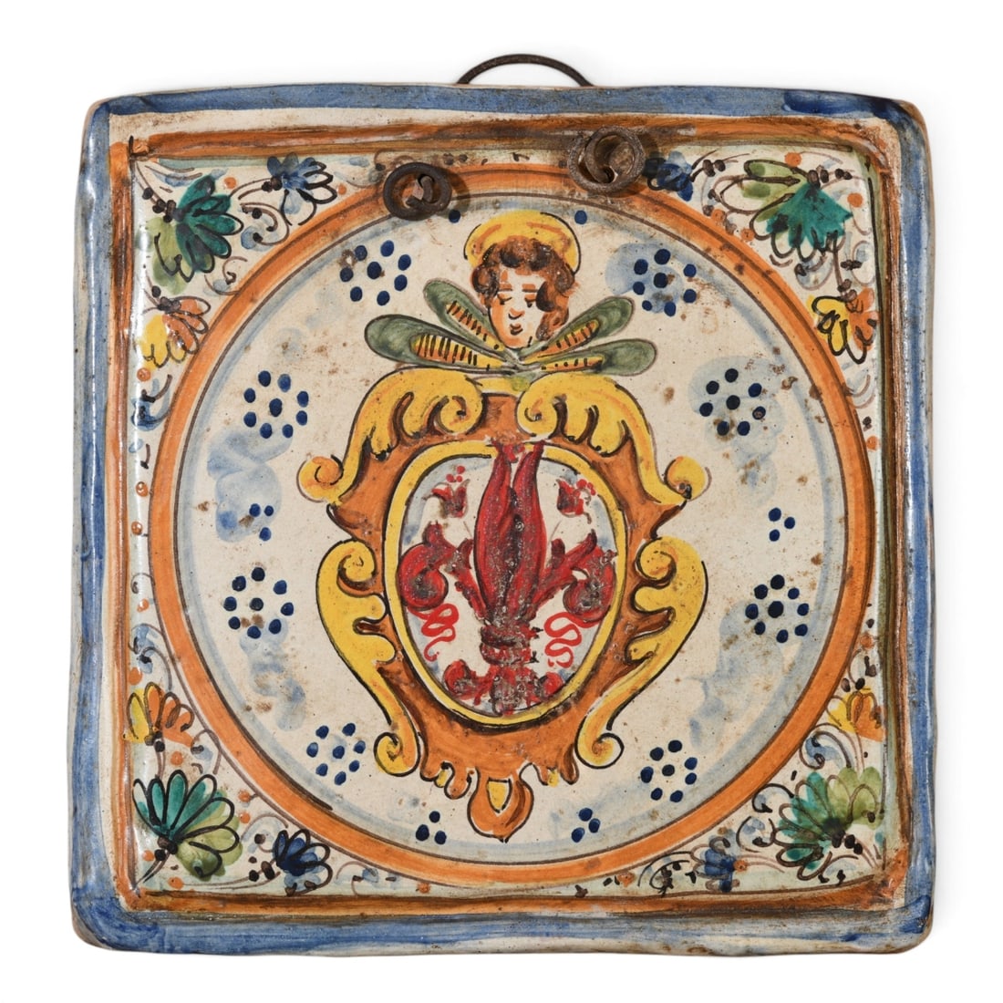 Italian Maiolica Armorial Wall Plaque: An Italian Neo-Renaissance maiolica wall plaque, late 19th/20th C. Hand-painted with the Florentine Fleur-de-lis and a cherub motif in cobalt blue, ochre, and copper green tin glazes. Features embedde
