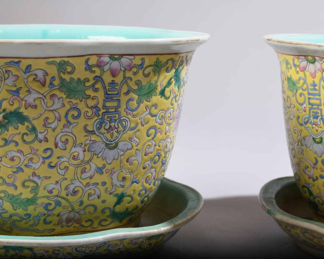 Pr. of Chinese Famille Jaune Porcelain Jardinieres: Each lobed foliate planter features lotus floral scrolls and Shou symbols on a yellow enamel ground, with turquoise glazed interiors and dual drainage holes. Set on matching under-plates. Undersides