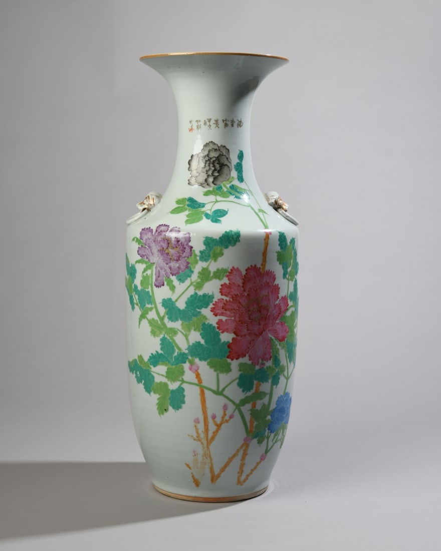 Chinese Famille Rose Polychrome Poem Vase: Baluster form vase with applied gilt beast-head handles. Hand painted with colorful peonies and inscribed with lines from Tang poet Luo Yin's Peony. Dimensions approx. 22 3/4" x 9" x 9". Our primary r