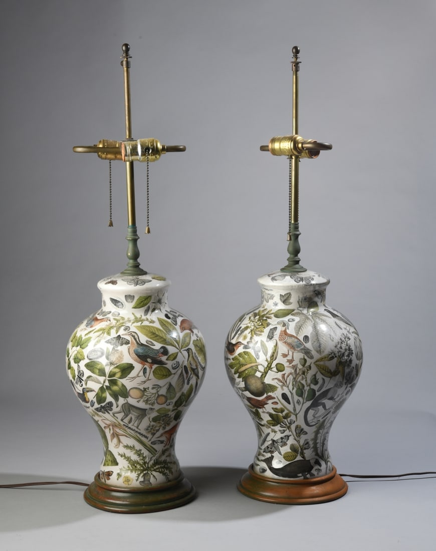 Pair of Decalcomania Glass Table Lamps: Featuring wildlife and floral images. Each on wooden base painted green, some chipping and fading to paint. Both power on. Height to top of finial approx. 30 1/2", diam. approx. 10". Our primary recom