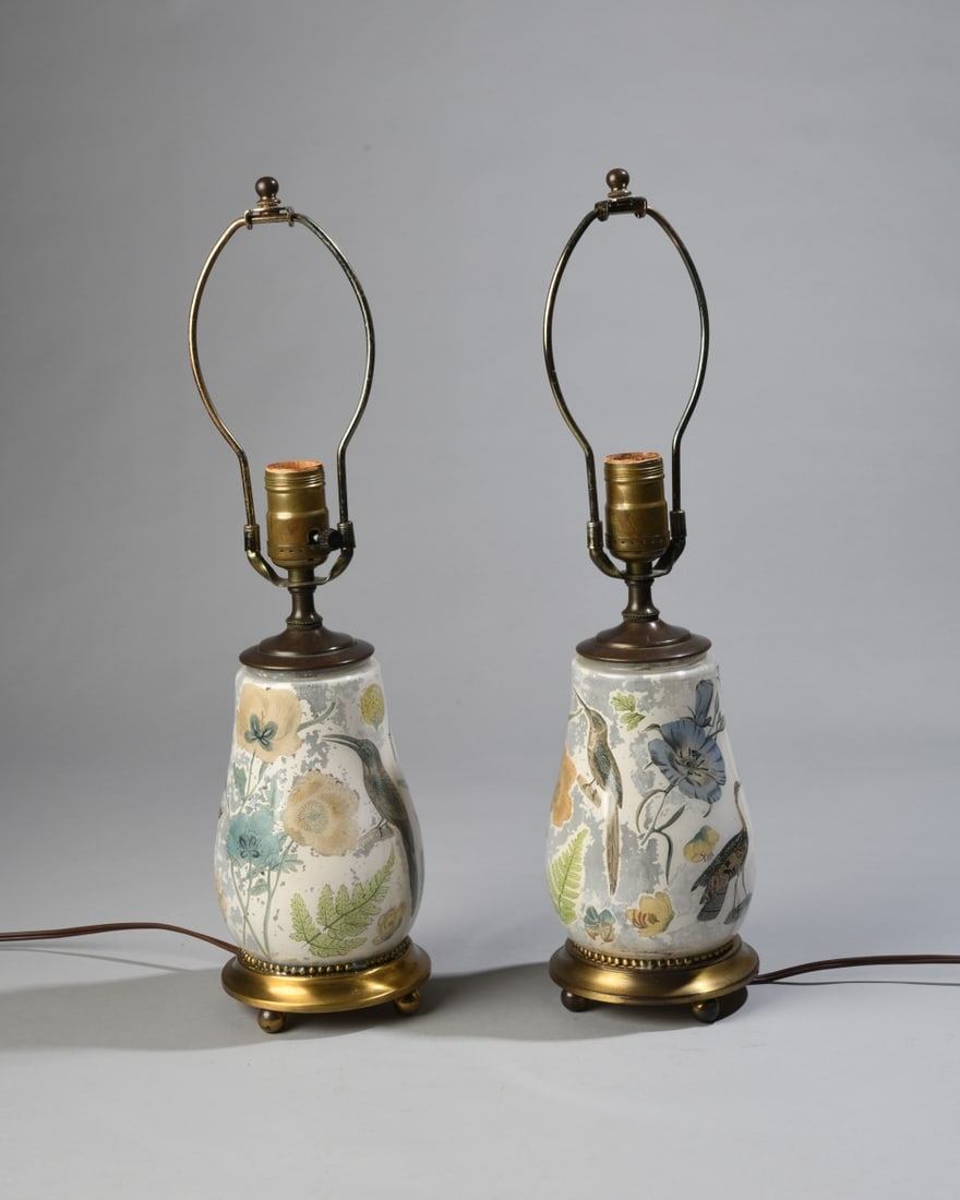 Pair of Decalcomania Glass Table Lamps: Featuring bird and floral images. Each on brass base. Both power on. Height to top of finial approx. 18" Our primary recommendation is to arrange shipping yourself using Blue Ridge Pack & Ship. Most b
