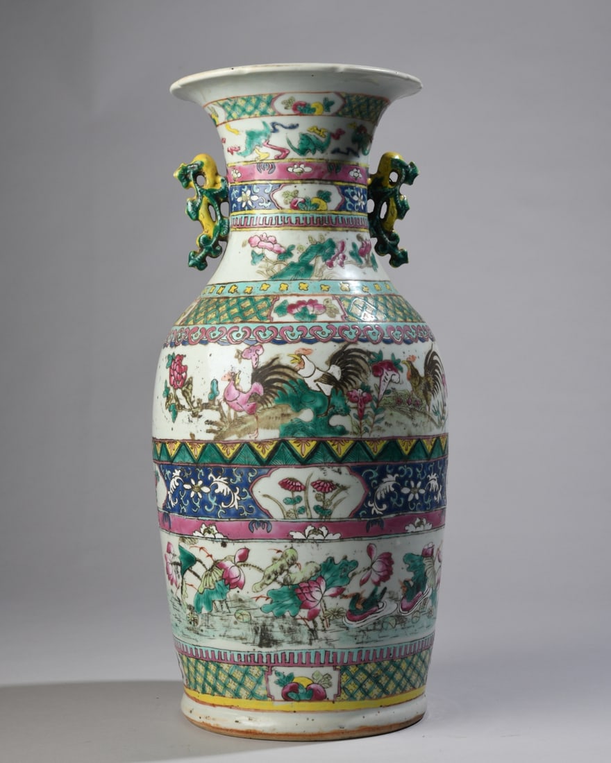 Chinese Famille Rose Rooster & Lotus Vase: A baluster form floor vase with applied molded handles, hand painted in thick polychrome enamels with roosters amongst blooming flowers. Probably late Qing. Visible vertical hairline. Dimensions
