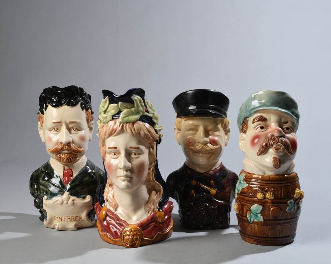 Four Continental Majolica Character Jugs: Group of four late 19th/early 20th century Continental glazed earthenware character jugs, including a figural jug inscribed "F. Ferrer," a barrel-form character jug, a uniformed man, and a female
