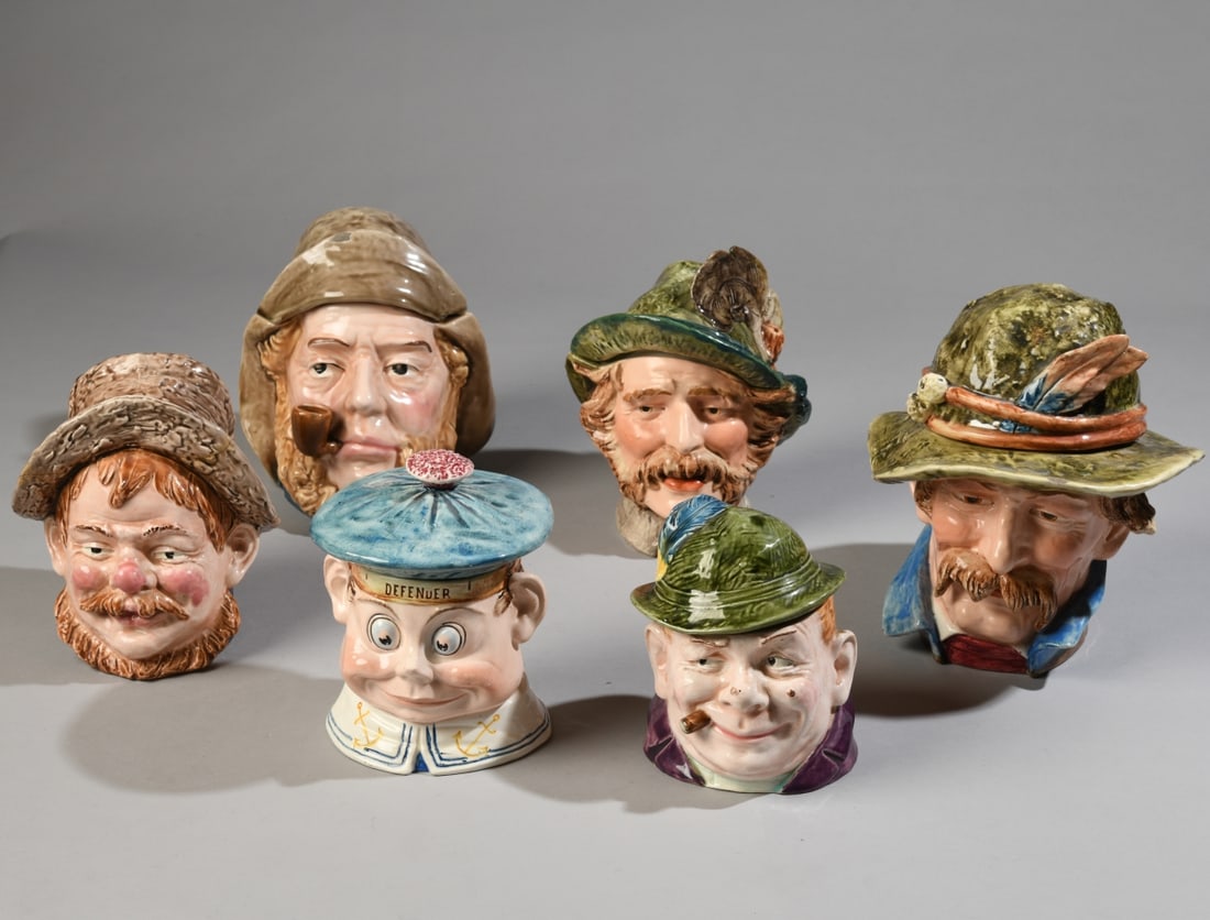 Six Figural Character Tobacco Jars: Early to mid 20th century glazed earthenware tobacco jars modeled as gentlemen wearing hats, impressed numerals to bases. Some chips and cracks / all in as-found condition. Approx. 8 1/4" x 8 1/2" x