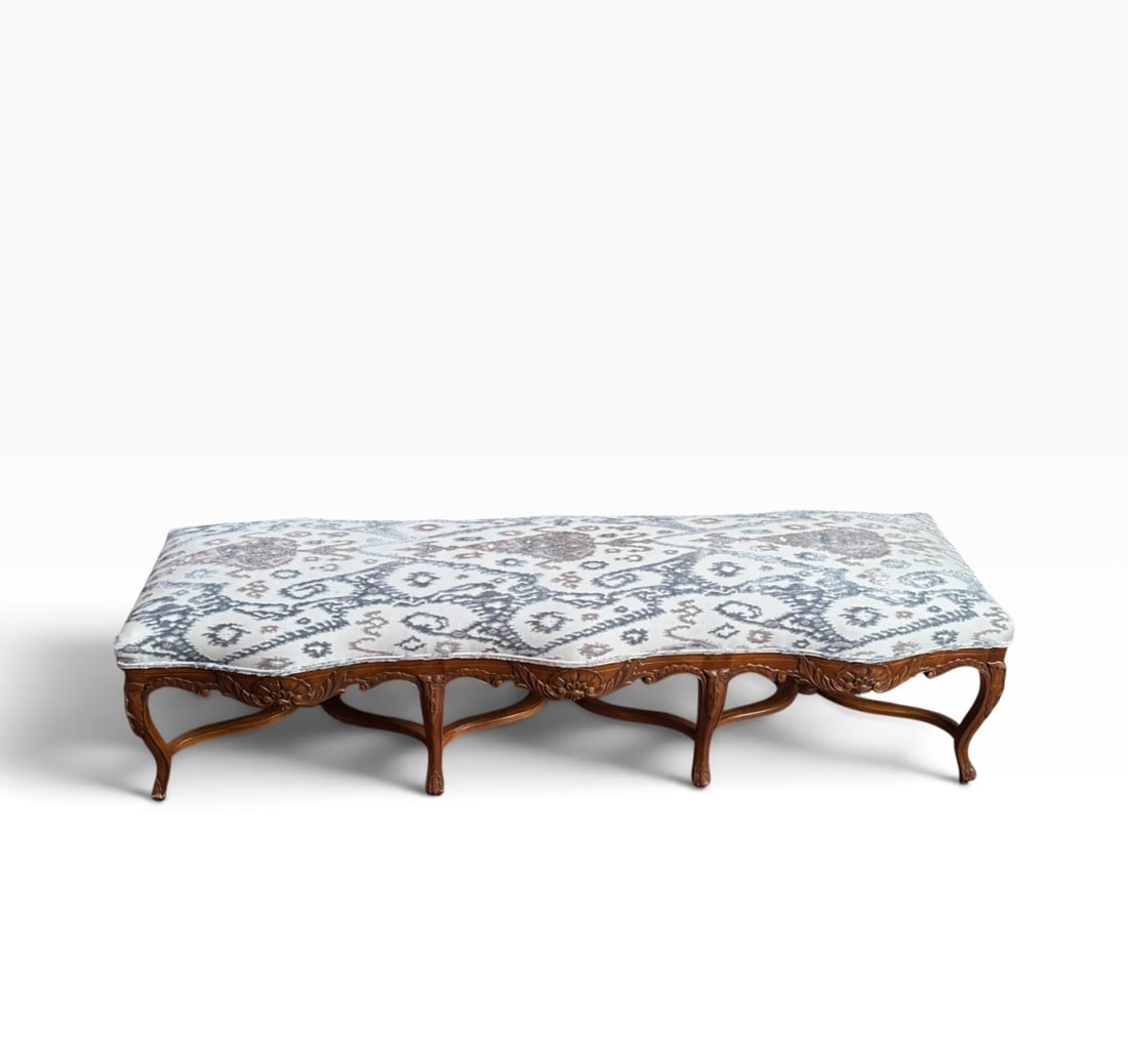 Louis XV Style Carved Wood Bench: A French Louis XV style bench featuring six carved cabriole legs and decorated with acanthus leaf and shell motifs, complemented by plush textured upholstery. Dimensions approx. 70" x 22" x 18 1/2".