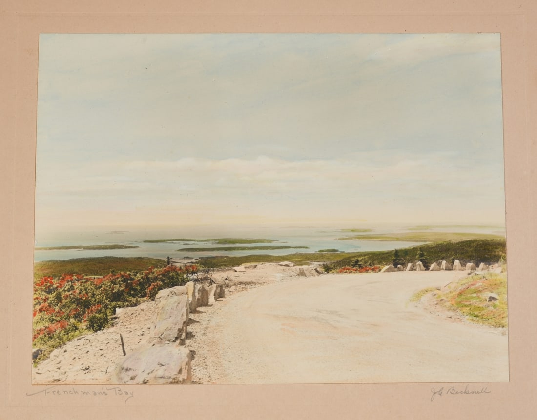 J. Carleton Bicknell (American, 1871 - 1956): Hand colored photograph depicting a coastal view of Frenchman's Bay, Maine, mounted to presentation board (tear to board), titled in pencil on mount at lower left and signed "J. C. Bicknell" on mount