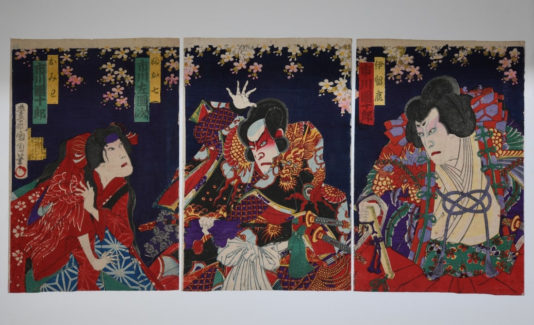 Toyohara Kunichika Kabuki Triptych: Toyohara Kunichika (Japanese, 1835 - 1900), color woodblock triptych depicting Kabuki actors. Unmounted, minor toning and surface wear, scattered creasing, rubbing and minor edge wear. Each sheet