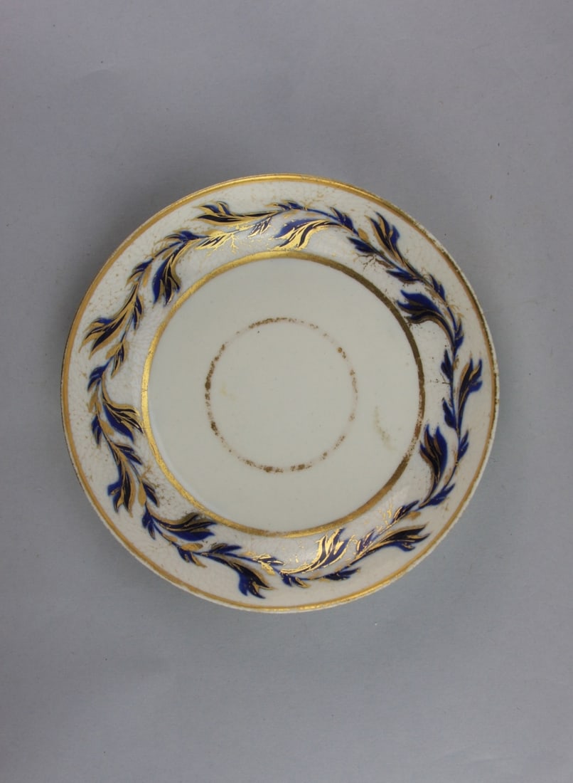 English Gilded Floral Decorated Porcelain Dish: English porcelain small dish or saucer with blue and gilded floral decoration, hallmark on back, circa 1800. Dia: approx. 5 1/2". Our primary recommendation is to arrange shipping yourself using Blue
