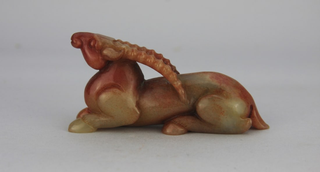 Chinese Carved Jade Sheep or Ram: Chinese carved celadon and cinnabar jade sheep or ram. Approx. 4 1/2" long. Our primary recommendation is to arrange shipping yourself using Blue Ridge Pack & Ship. Most bidders find this is the most