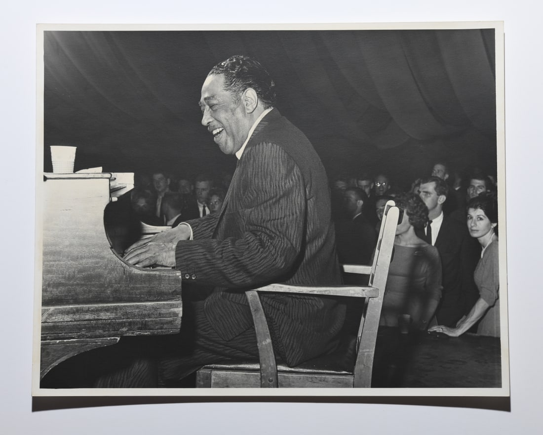 Ed Roseberry (American 1925 - 2022) Duke Ellington: Duke Ellington performing at Memorial Gymnasium, University of Virginia, Charlottesville, November 1961. Unmounted, red stamped "PHOTOGRAPHED BY ED ROSEBERRY" and date to verso. Approx. 14" x 11".