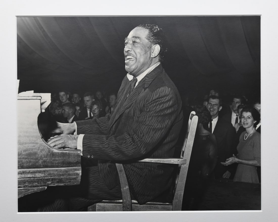 Ed Roseberry (American 1925 - 2022) Duke Ellington: Duke Ellington performing at Memorial Gymnasium, University of Virginia, Charlottesville, November 1961. Mounted to matting, pencil signed and dated to inner mat. Approx. 14" x 11". Matting approx.