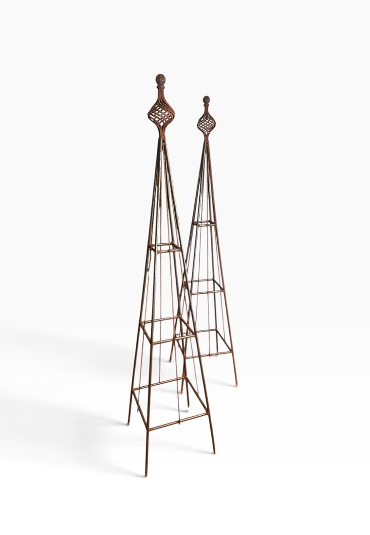 Pair of Vintage Garden Obelisk Trellises: A matching pair of tall, tapered steel garden obelisks with decorative twisted wire finials. Dimensions approx. 81 1/2" x 17 1/2" x 17 1/2". Our primary recommendation is to arrange shipping yourself 