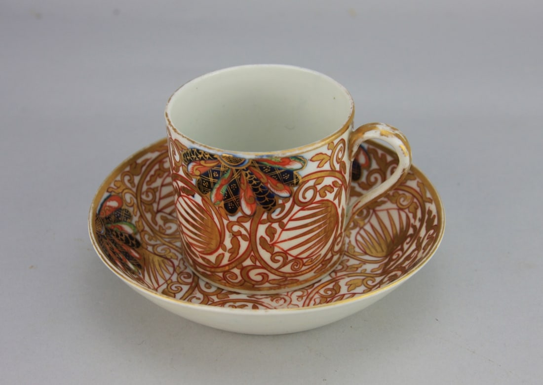 Antique English Porcelain Cup & Saucer: English gilded and enamel decorated porcelain cup and saucer, circa 1800, decorated in the imari palette, probably by Hall. Saucer is 5" in diameter, cup is 2 1/2" high, slight loss to the gilding. Ou
