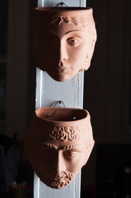 Pair English Garden Pottery Terracotta Planters: Two vintage earthenware wall planters in the form of male and female classical faces, Both marked with the stamp of Rookes Pottery, Derbyshire, England. Each aprox 6 1/2" H x 6 1/2" W, 5" D.