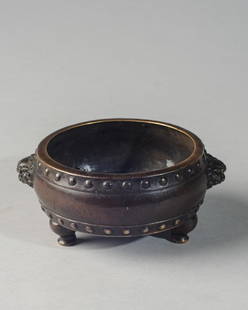 Antique Chinese Qing Bronze Tripod Censer: Chinese bronze drum-form tripod censer with two lion-head handles, two bands of bosses at mouth and foot rims. Six character Xuande mark in rectangle to base. Bronze has deep brown patina. Ming mark b