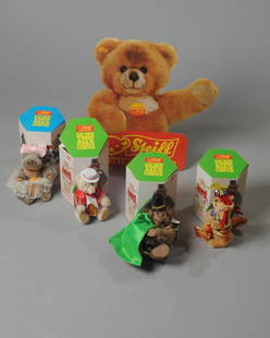 Four Steiff Golden Age of the Circus Animals: Fat Lady Hippo number 941, Fire Eater Dragon number 62, Strong Man Gorilla, Food Vendor Teddy Bear number 720, all in original boxes, together with a Molly Teddy Steiff cardboard sign.