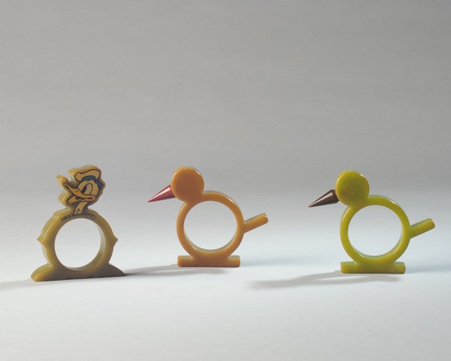 Three Bakelite Napkin Rings: One Donald Duck, and two bird forms.