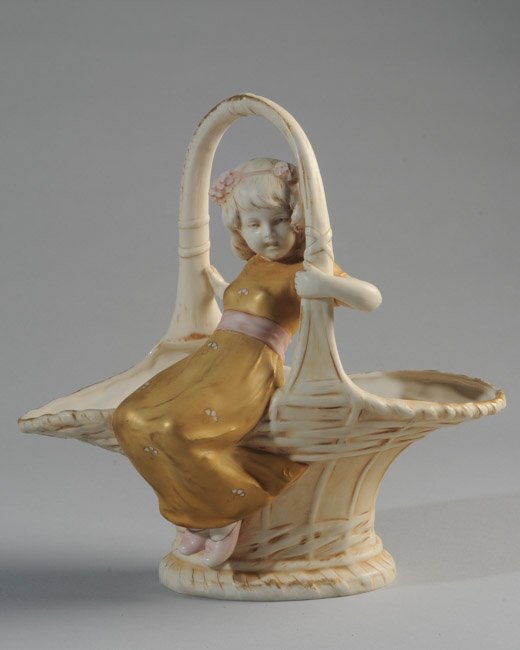 Royal Dux Porcelain Basket: Young girl grasping handle, triangle mark to base. H: approx. 10 1/2". W: approx. 10 1/2". D: approx. 6".
