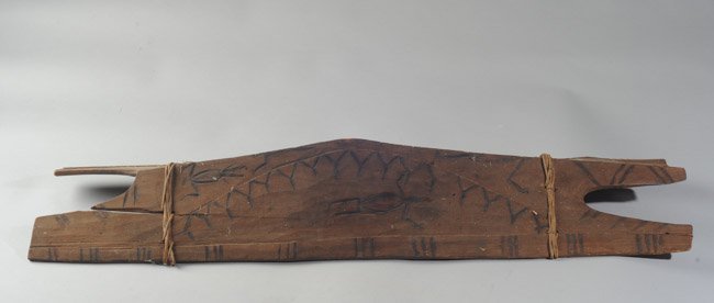 Early South Seas or African Tribal Shield: Animal images and carving, splits to wood, recessed handle, many signs of wear. Approx. 32" x 8 1/12".