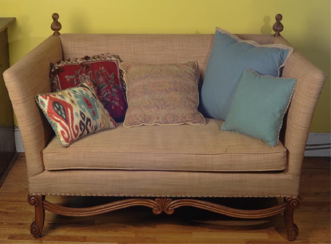 High Back Settee: High back and arms, finials to the back, carved elements, single cushion. W: approx. 56 1/2".