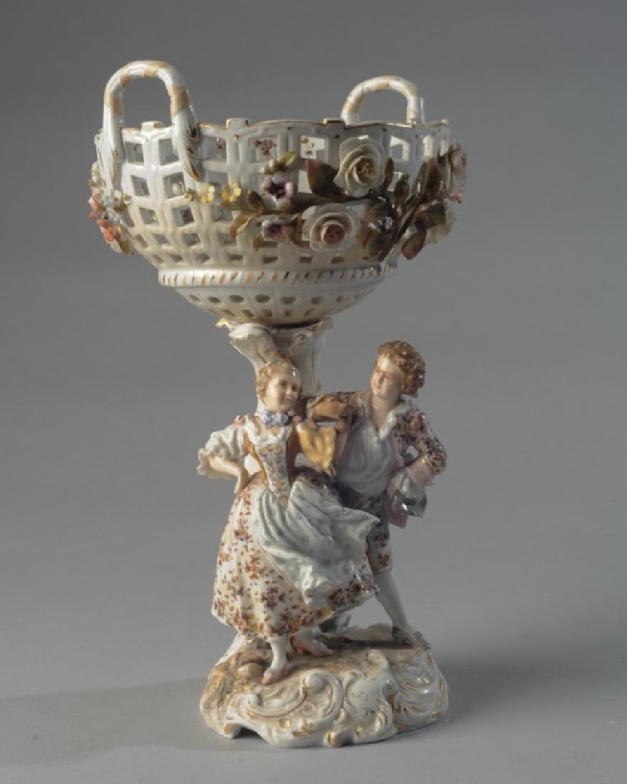 19th C. Continental Compote: Relief of young man and maiden, together with elaborate floral relief, 2 sections, marked to base. H: approx. 12". Dia: approx. 7".