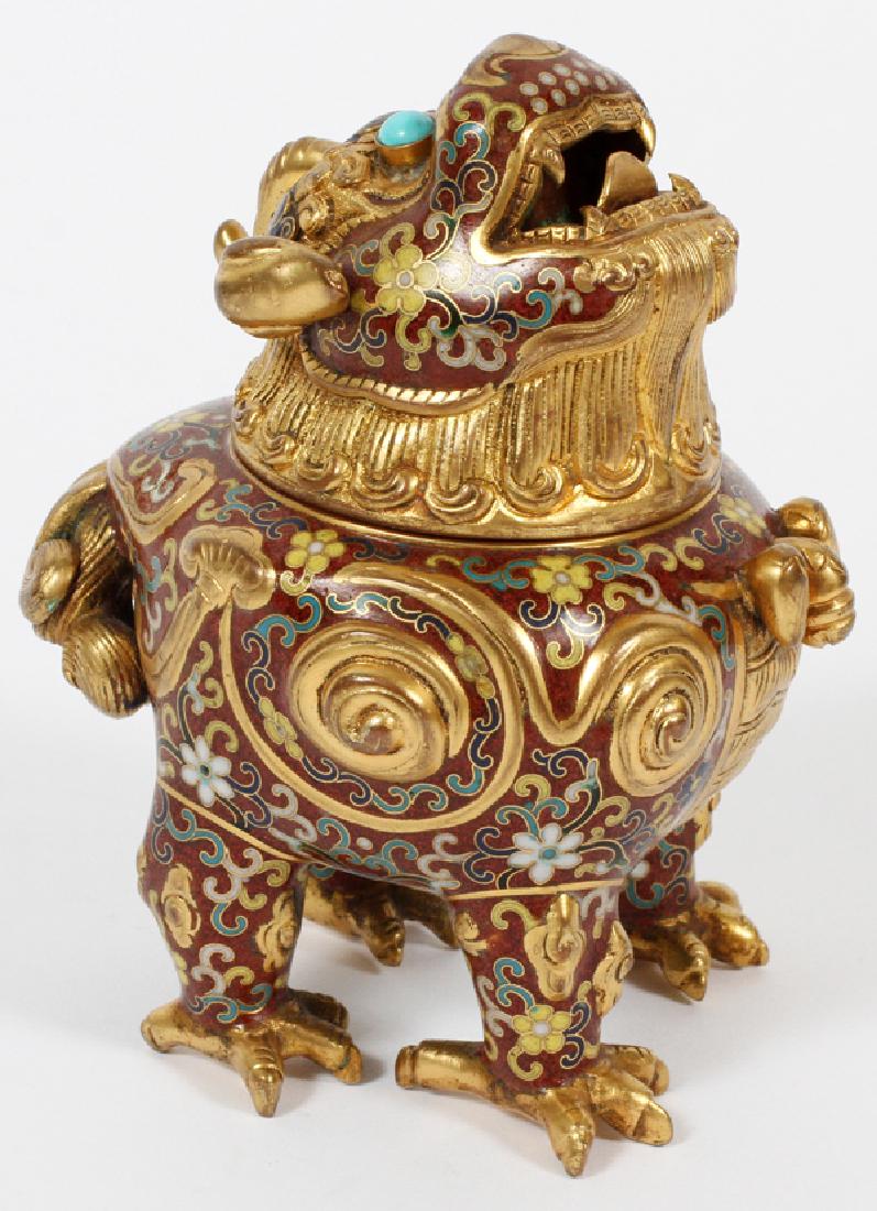 CHINESE GILT BRASS & CLOISONNE INCENSE BURNER: CHINESE, GILT BRASS AND CLOISONNE, FOO DOG INCENSE BURNER, H 5":Chinese gilt bronze and cloisonne foo dog incense burner having a burgundy ground and turquoise eyes.