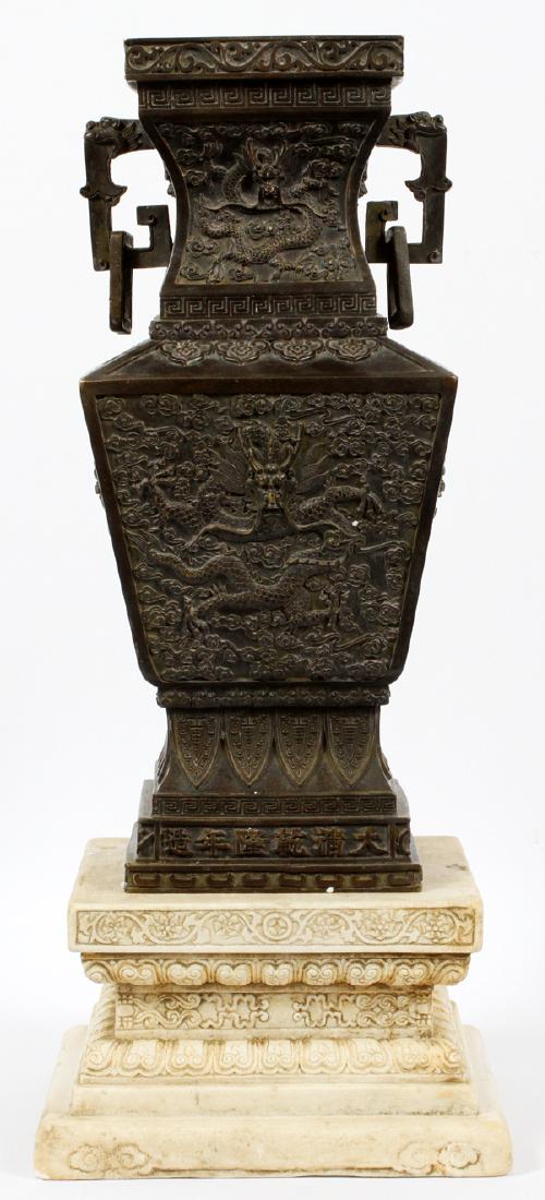CHINESE RAISED RELIEF DRAGON DESIGN BRONZE VASE: CHINESE, RAISED RELIEF DRAGON DESIGN, BRONZE VASE, H 16", W 7", L 7":stone base, 7" square, 4" H., double elephant handles.