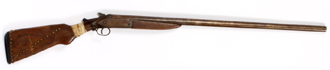SINGLE BARREL SHOTGUN: SINGLE BARREL SHOTGUN L 47":Single shot 12 gauge shotgun. Having walnut stock and splinter forearm. Brass nails imbedded in the shoulder stock, rawhide wrap at the wrist. Signed "Long Range Wh___" to 