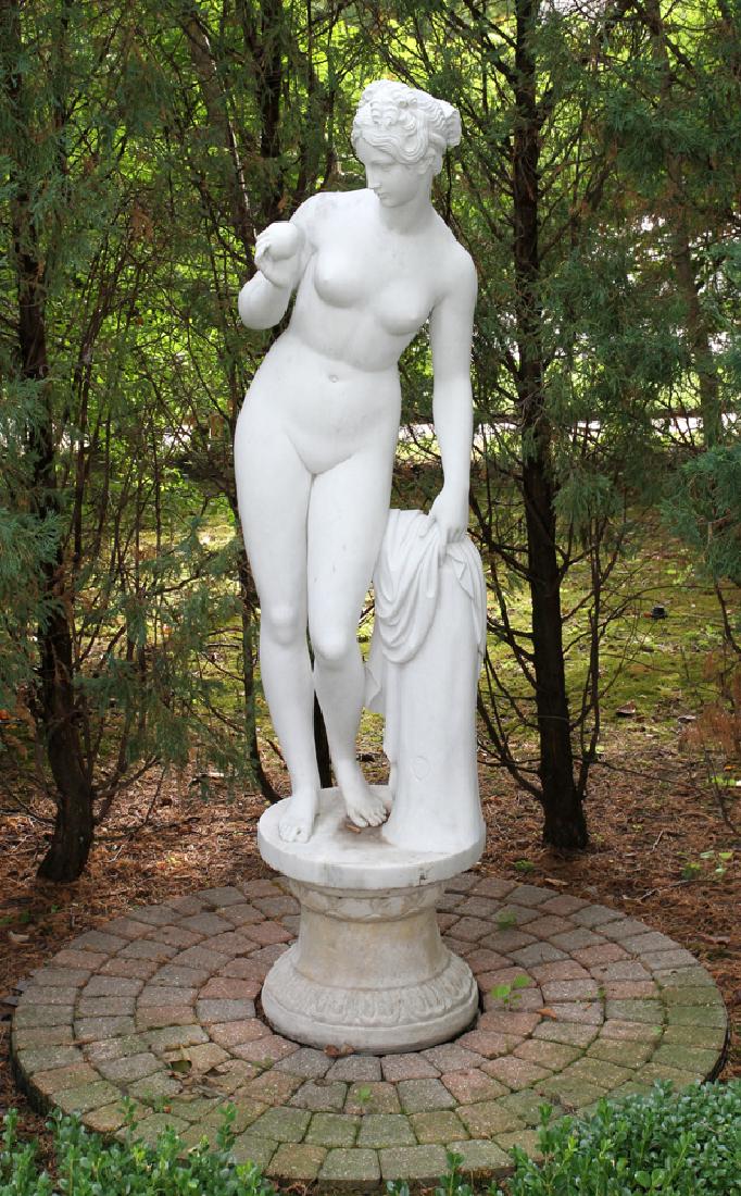 E. BERTONI CARVED CARRARA MARBLE SCULPTURE OVERALL: E. BERTONI, CARVED CARRARA MARBLE SCULPTURE, H 71" OVERALL:A carved Carrara marble life size figure of Venus holding an apple and leaning against a stump. Mounted on a cement base, H.17". From The Geo