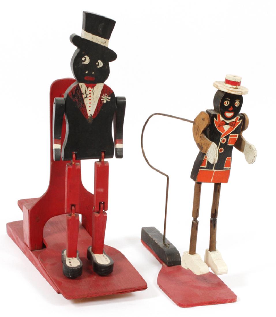 BLACK AMERICANA WOOD AND METAL DANCING TOYS TWO: BLACK AMERICANA WOOD AND METAL DANCING TOYS, TWO:Featuring a paddle puppet dancing man with top hat H 16" and a jigging dancer with a bow tie, white hat and shoes.