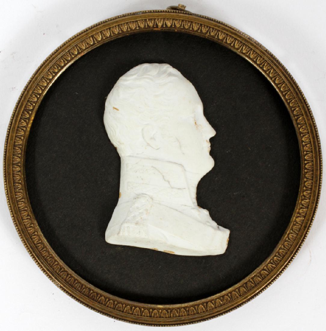 BISQUE PORTRAIT MILITARY OFFICER C. 1800 FRAMED: BISQUE PORTRAIT, MILITARY OFFICER, C. 1800, L 1 3/4", FRAMED, DIA 4":A bisque portrait in profile mounted on paper and set in a circular brass frame with convex glass, Dia.4 1/4".