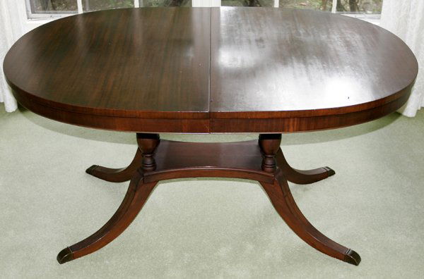 DUNCAN PHYFE STYLE MAHOGANY DINING TABLE L56": DUNCAN PHYFE STYLE MAHOGANY DINING TABLE, H 29", W 38", L 56", PLUS THREE LEAVES:Oval top, extension style, having four pillars raised on a plinth on four splay legs. Leaves measure 12" wide. Ex. Esta