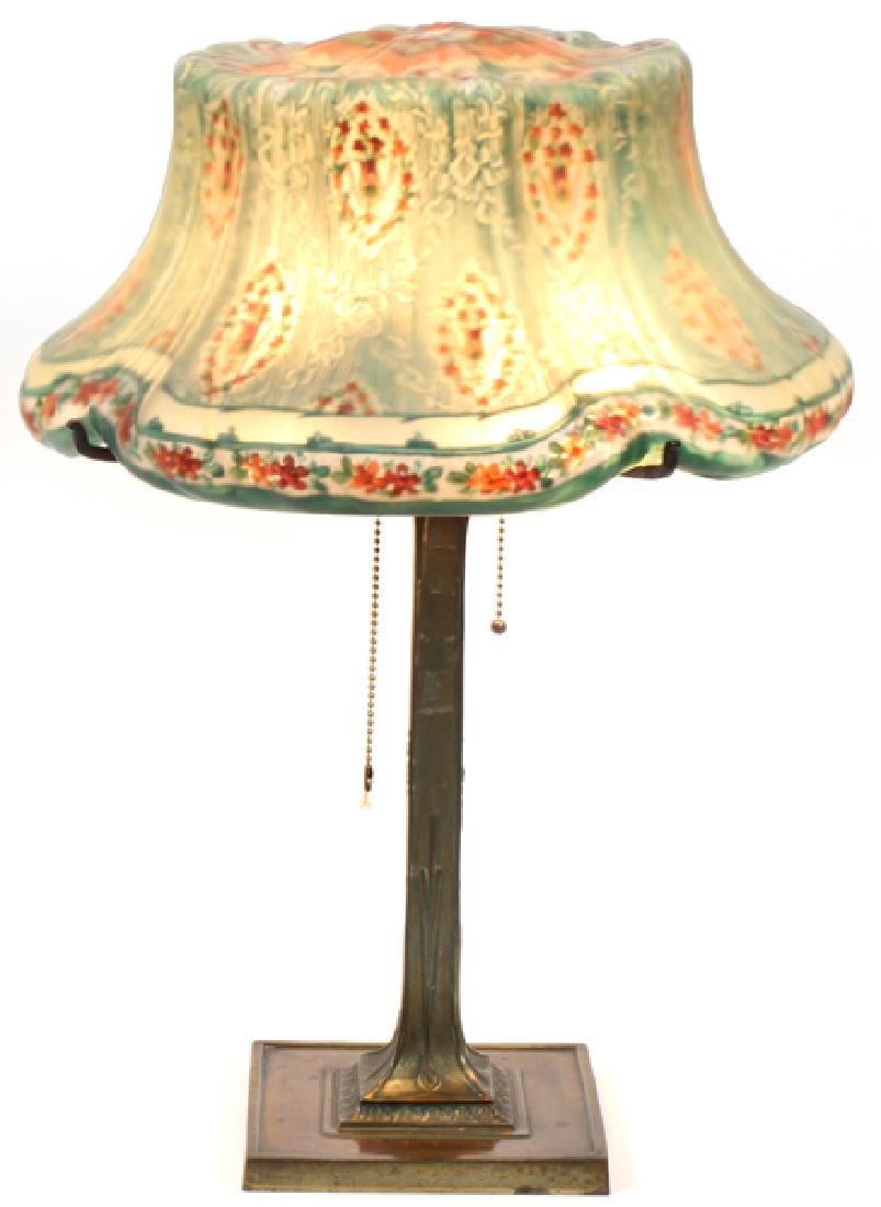 PAIRPOINT REVERSE PAINTED SHADE LAMP & BASE: PAIRPOINT REVERSE PAINTED SHADE LAMP & BASE, H 21", W 15":A lobed glass shade painted with a ground of vertical green striping with interspersed floral vignettes and ribbon swag. Over a squared bronze
