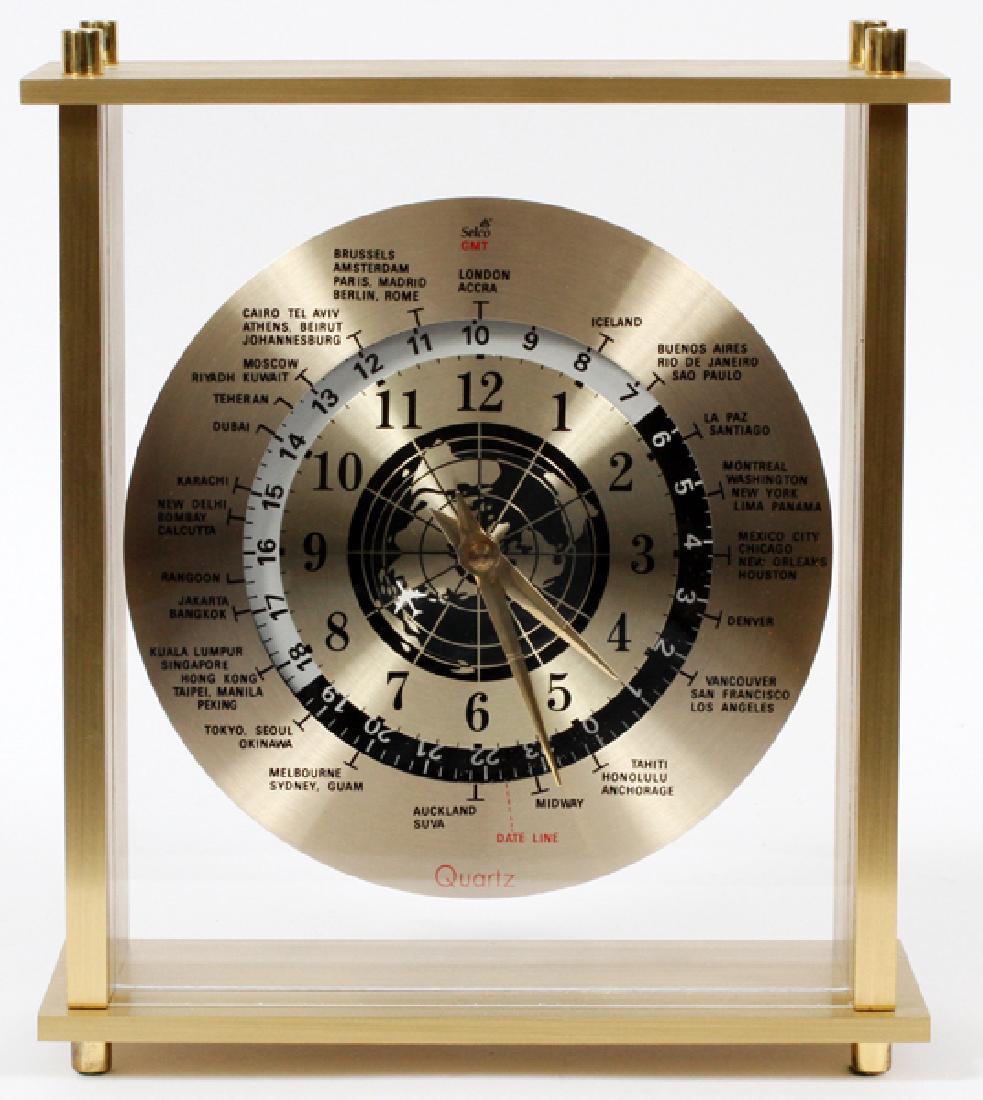SELCO GMT QUARTZ CLOCK: "SELCO GMT", QUARTZ CLOCK, H 9 1/4", W 8":A brushed brass quartz movement clock; the face with various locations about the world. Inscribed on verso "Made In Taiwan".