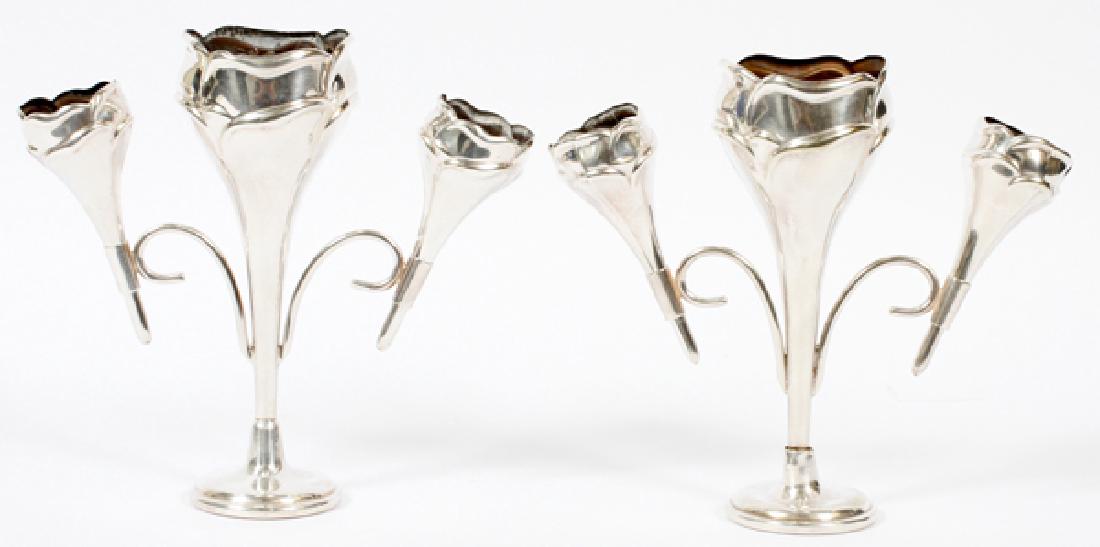 ENGLISH SILVER PLATE EPERGNES I. FREEMAN & SON PAIR: ENGLISH SILVER PLATE EPERGNES, I. FREEMAN & SON, PAIR, H 7 1/2", W 8":A pair of silver plate epergnes, by Israel Freeman & Son; each with a weighted base and three floral-form vessels. Marked at the e