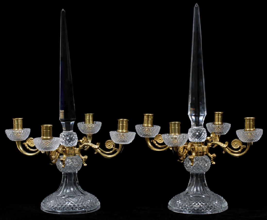 FRENCH BRONZE AND CRYSTAL CANDELABRA 20TH C. PAIR: FRENCH BRONZE AND CRYSTAL CANDELABRA, 20TH C., PAIR, H 18", W 12":Each with a faceted obelisk finial, above a gilt bronze divider issuing four scrolling arms with crystal hobnail cut drip-pans, restin