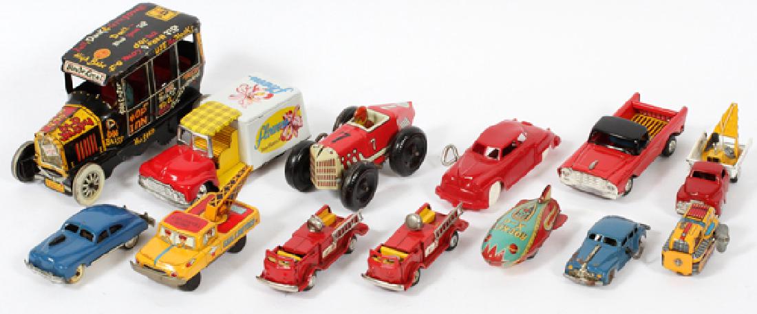 TIN WIND-UP & FRICTION FLY WHEEL TOYS TRUCKS & CARS: TIN WIND-UP AND FRICTION FLY WHEEL TOYS, TRUCKS, BLIMP AND CARS, MID 20TH C, 13 PCS, H 2 1/2" - 6 1/2":includes eight friction fly-wheel toys: 2 tow trucks, 2 fire trucks, a blimp, Chevy El Camino and