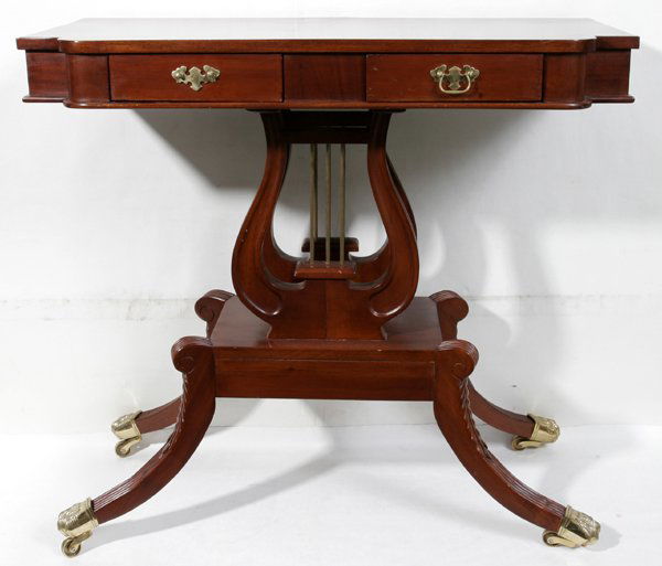 DUNCAN PHYFE MAHOGANY PARLOR TABLE, C.1950: DUNCAN PHYFE MAHOGANY PARLOR TABLE, C 1950, H 33", W 36", D 18":having two small drawers across front; harp design pedestal and curved legs with brass paw feet with casters.