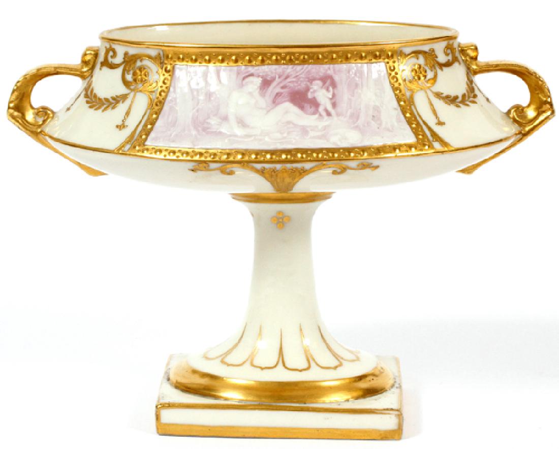 MINTONS PATE-SUR-PATE PORCELAIN COMPOTE BY BIRKS: MINTONS PATE-SUR-PATE PORCELAIN COMPOTE BY ALBOIN BIRKS, C.1895, H 5 1/2", W 7 1/2":A squared reserve of pink-purple ground depicts a resting Diana the Huntress near-by a hunting dog and a putti, encl