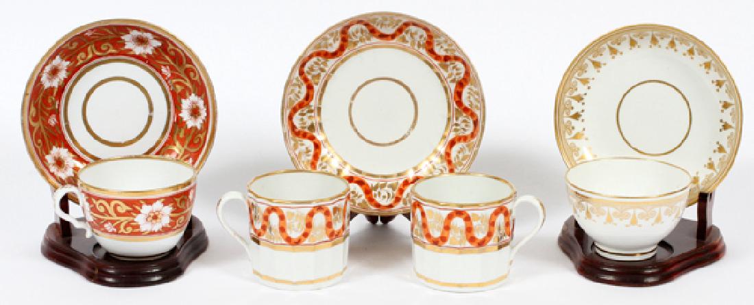 GROUP OF HAND-PAINTED CUPS AND SAUCERS 7 PIECES: GROUP OF HAND-PAINTED CUPS AND SAUCERS, 7 PIECES, H 3", DIA 6":Having a cup and saucer with hand-painted red and fired gold foliate Asian-influenced band around the body of the cup and the lip of the