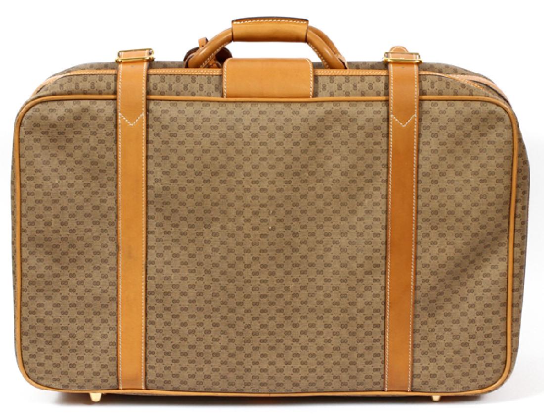 GUCCI BROWN MONOGRAM CANVAS SUITCASE: GUCCI BROWN MONOGRAM CANVAS SUITCASE, H 16 1/2", W 20", D 6 3/4'':A vintage piece having brown leather handle and goldtone hardware, including a zipper closure and two buckle reinforcements. Includes