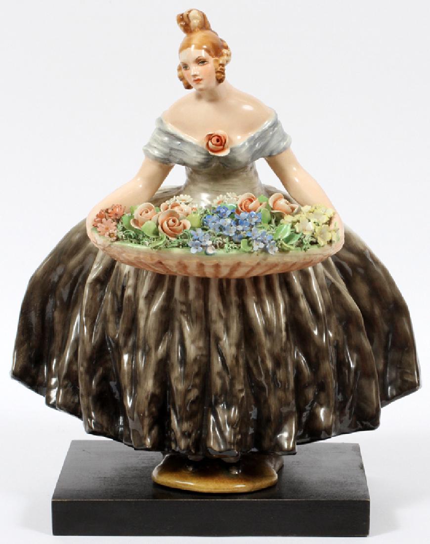 POTTERY FIGURE GIRL HOLDING FLOWER BASKET: POTTERY FIGURE GIRL HOLDING FLOWER BASKET, H 13" W 10":Upon a Black Base. - There are Three Color Photos showing this Piece including the Signature.