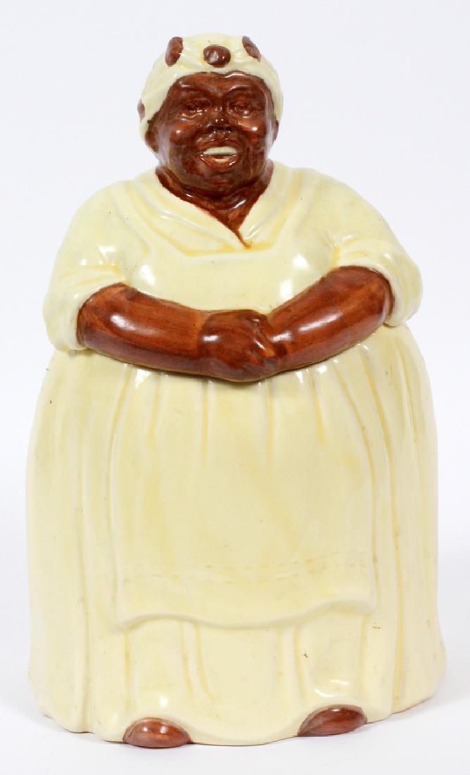 YELLOW HAND PAINTED POTTERY AUNT JEMIMA COOKIE JAR: YELLOW HAND PAINTED POTTERY AUNT JEMIMA COOKIE JAR, H 13":Depicted in a light yellow dress and head scarf with brown dots. no mark.