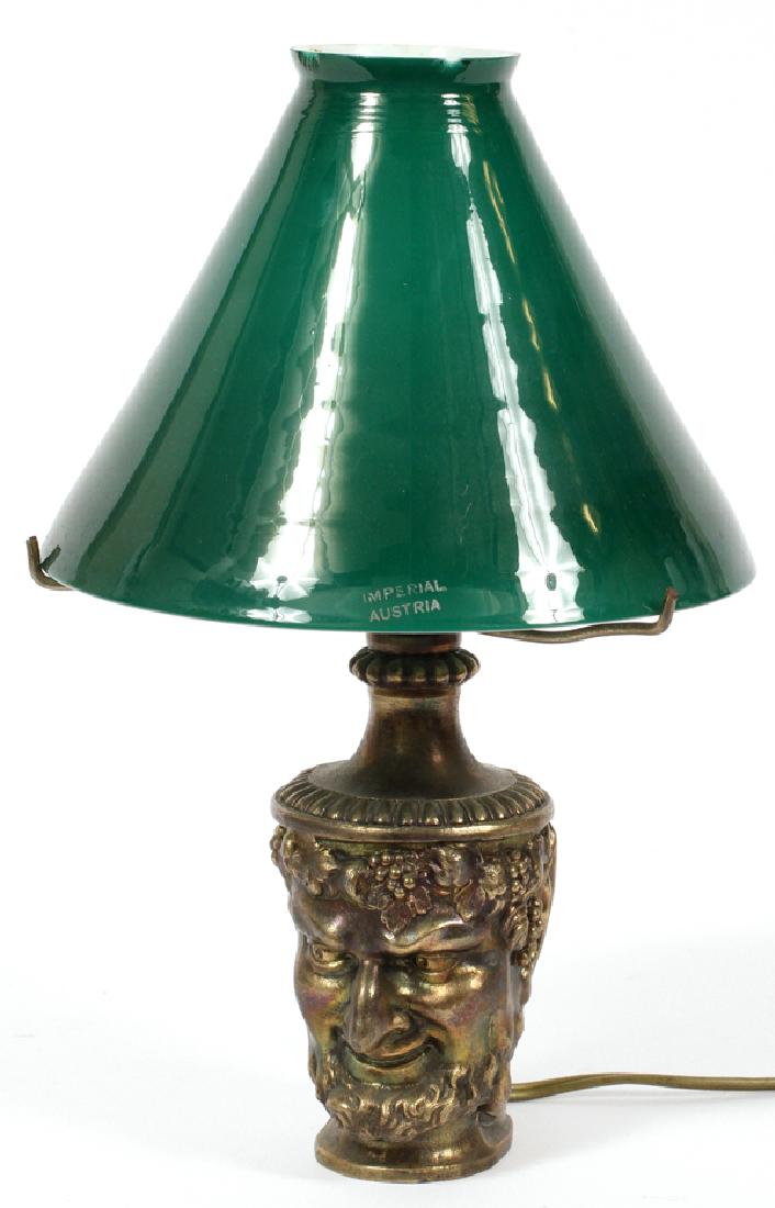 BRADLEY & HUBBARD GILT TONE BACCHUS LAMP: BRADLEY & HUBBARD GILT TONE BACCHUS LAMP, H 11":A green glass shade; above a Bacchus cup form base. Marked to the underside (see additional photo). Measures Dia.6 3/4". Electrified.