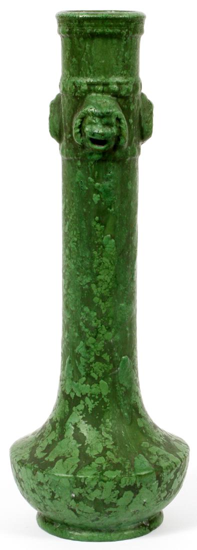 ROZANE WARE BY ROSEVILLE 'EGYPTO' POTTERY VASE: ROZANE WARE BY ROSEVILLE, 'EGYPTO' POTTERY STICK VASE, C1920, H 15", DIA 5":Having a green ground, narrow cylindrical neck with dogs/lion masks, with open mouths, at the top. Expands to a wider round