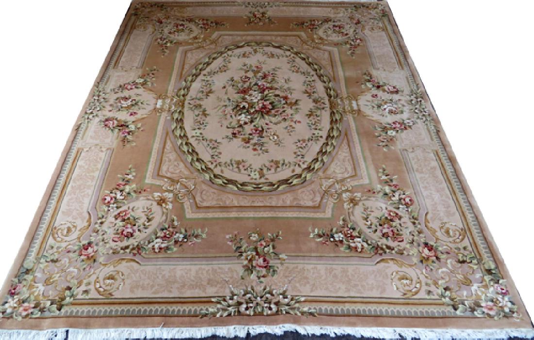 FRENCH AUBUSSON STYLE PINK FLORAL RUG: FRENCH, AUBUSSON STYLE, PINK FLORAL RUG, W 8', L 9' 10'':A large fringed rug with a light pink ground and traditional French floral design on a single center medallion with a large, beige border. W 8'
