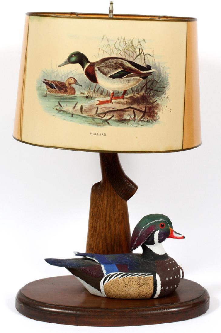 LOUIS LEHMAN HAND CARVED & PAINTED DECOY LAMP: LOUIS LEHMAN (LATE 20TH C), HAND CARVED AND PAINTED, 'WOOD DUCK', DECOY LAMP, LATE 20TH C, H 27", W 18", D 11",:Louis Lehman hand carved lamp with a 'wood duck' decoy mounted on the base of the lamp. 