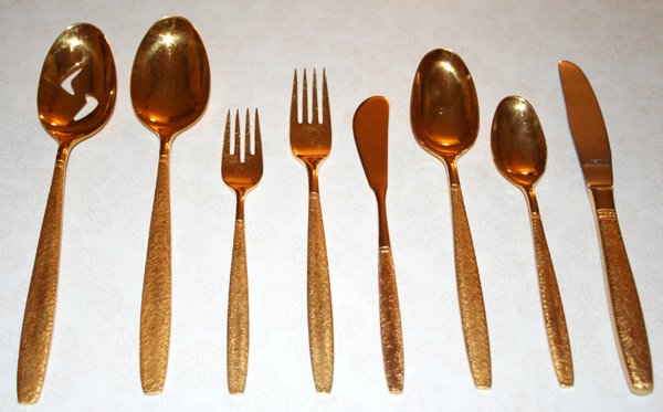SET OF GOLD PLATED FLATWARE, 86 PCS.: SET OF GOLD PLATED FLATWARE, 86 PCS.:Includes 12 dinner knives, 24 teaspoons, 12 tablespoons, 12 butter knives, 12 dinner forks, 12 luncheon forks, 2 serving spoons. Ex. Estate of Kathleen T. DeVlieg,