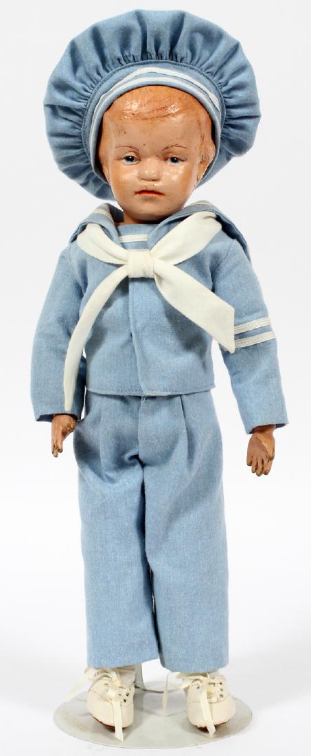 SCHOENHUT CARVED WOOD BOY DOLL C.1930: SCHOENHUT CARVED WOOD BOY DOLL, C.1930, H 14":Fully-jointed boy doll, 14/201 with painted blue eyes and carved hair. Original label to the back. Reference: Schoenhut Dolls, A Collector's Encyclopedia,